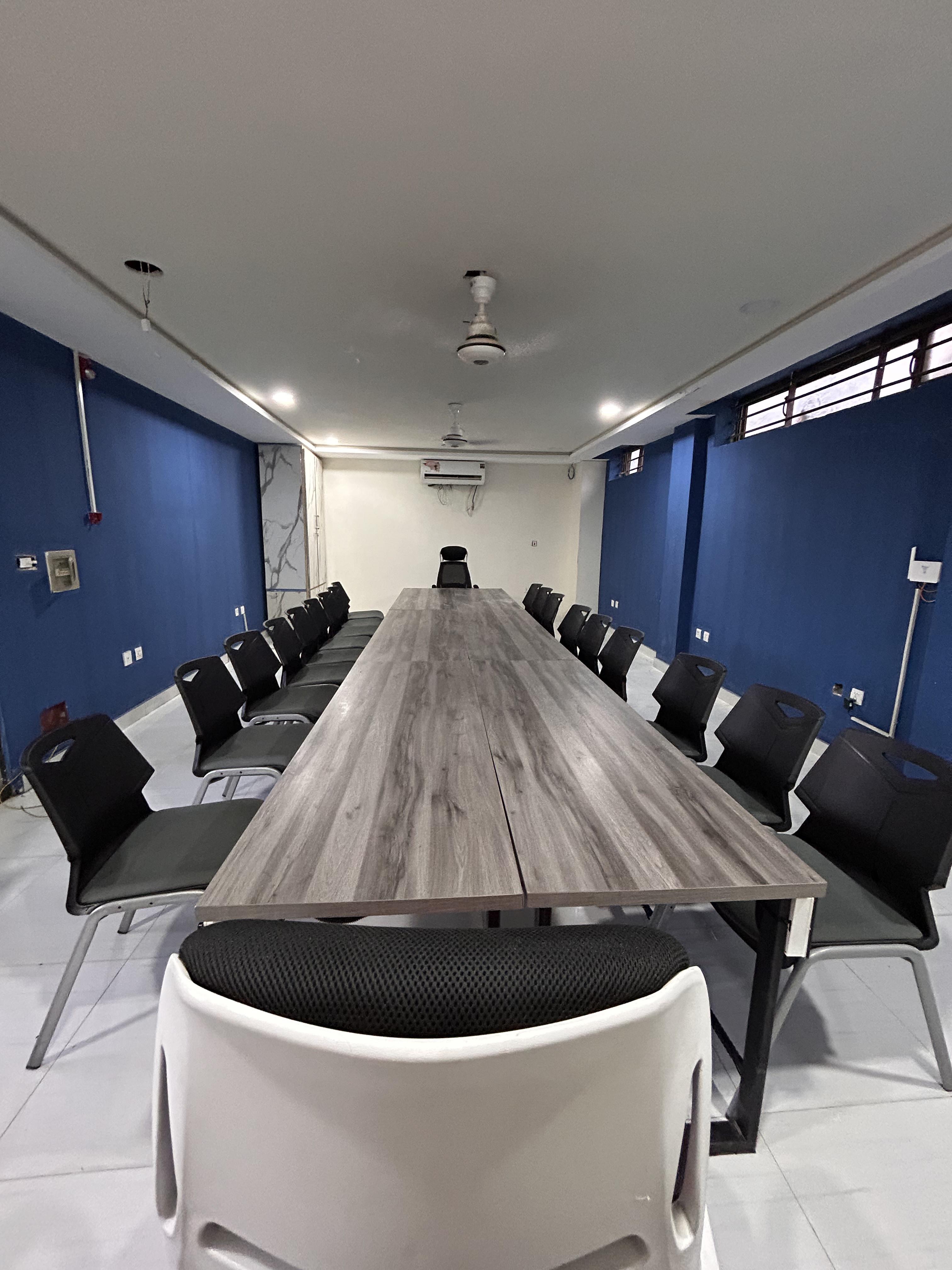 Wide view of basement conference room with meeting table